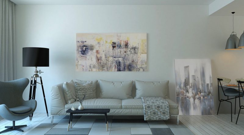 mieszkanie minimalistyczne - sofa, dywan, obraz i lampa